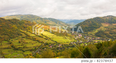 rural landscape in mountains. cloudy autumn weather. village in the distant valley 82378437
