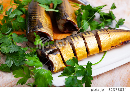 Slices of smoked mackerel served with greens Slices of smoked mackerel served with greens 82378834