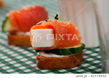 Canape with salmon, young cheese, cucumber Canape with salmon, young cheese, cucumber 82378930
