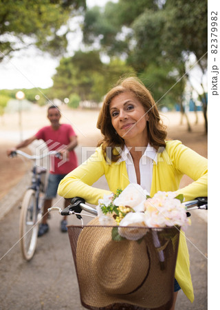 Portrait of happy mature couple riding bikes Portrait of happy mature couple riding bikes 82379982
