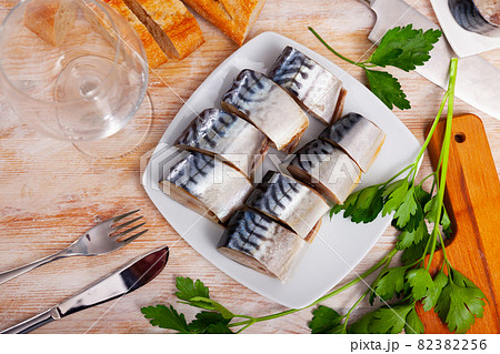Slices of lightly salted mackerel with greens at plate Slices of lightly salted mackerel with greens at plate 82382256