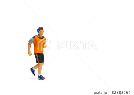 Miniature people, Man in fitness wear running on white background Miniature people, Man in fitness wear running on white background 82382564
