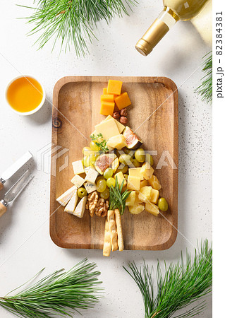 Cheese platter with different cheese and grapes, nuts, olive, figs. Festive gourmet appetizer. 82384381