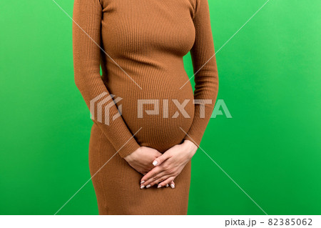 urinary incontinence during pregnancy. Abdominal pain during pregnancy. Maternity healthcare concept on colored background urinary incontinence during pregnancy. Abdominal pain during pregnancy. Maternity healthcare concept on colored background 82385062