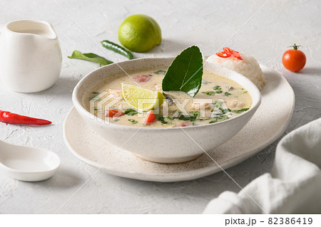Spicy coconut Tom Kha Gai soup with chicken, cherry tomato. Asian Thai food. 82386419