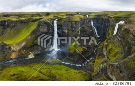 Dramatic landscape of epic Haifoss Waterfall in Landmannalaugar canyon, Iceland. Aerial panoramic drone view 82386791