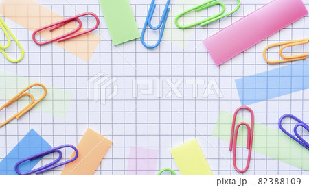 Multicolored stickers and paper clips on the blank checkered page. Multicolored stickers and paper clips on the blank checkered page. 82388109