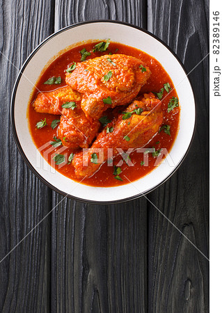 Ayam masak merah is a Malaysian traditional dish it is a casserole of chicken pieces in dried chillies sambal close-up in a bowl. Vertical top view Ayam masak merah is a Malaysian traditional dish it is a casserole of chicken pieces in dried chillies sambal close-up in a bowl. Vertical top view 82389146
