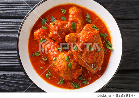 Spicy Tomato Chicken Ayam Masak Merah close-up in a bowl. Horizontal top view Spicy Tomato Chicken Ayam Masak Merah close-up in a bowl. Horizontal top view 82389147