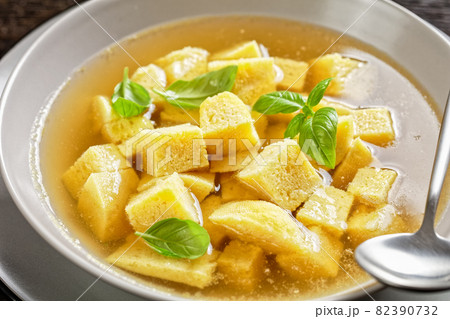 soup of chicken broth with parmesan egg dumplings soup of chicken broth with parmesan egg dumplings 82390732