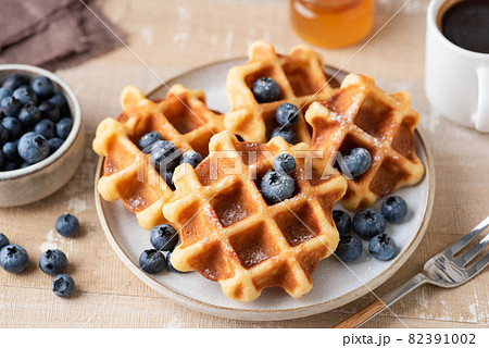 Belgian waffles with blueberries on plate 82391002