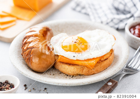Tasty breakfast toast with cheese, egg and sausage 82391004