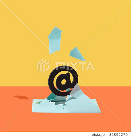At, email sign, burst out of a blue envelope against orange and yellow background. At, email sign, burst out of a blue envelope against orange and yellow background. 82392279