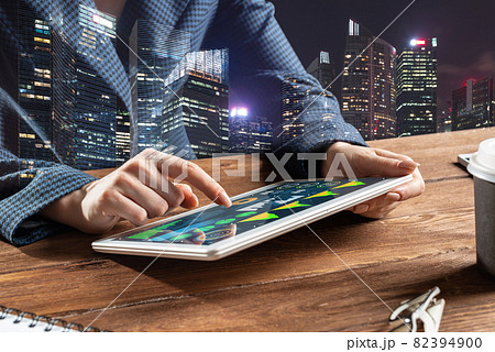 Businesswoman using tablet computer at desk 82394900