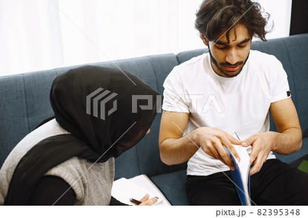 Young students, arab couple preparing for exams in apartment interior 82395348