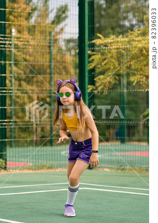 Schoolgirl preteen resting on sports ground Schoolgirl preteen resting on sports ground 82396033