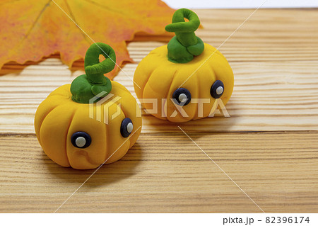 Halloween party background, Fondant paste figure pumpkin on wooden rustic background, copy space, card, invitation, cupcakes topper halloween 82396174