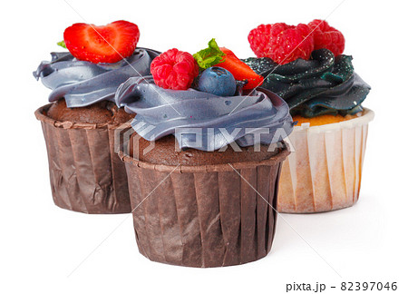 Three tasty cupcakes with cream topping isolated on white Three tasty cupcakes with cream topping isolated on white 82397046