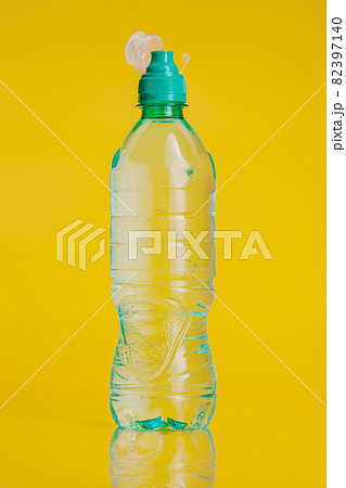 Plastic bottle of mineral water on a bright yellow background Plastic bottle of mineral water on a bright yellow background 82397140