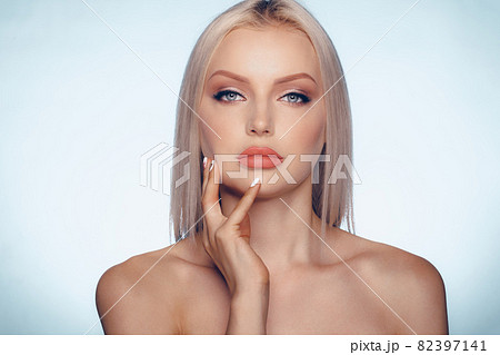 Close up beauty portrait of a blonde woman with perfect skin and plump lips Close up beauty portrait of a blonde woman with perfect skin and plump lips 82397141