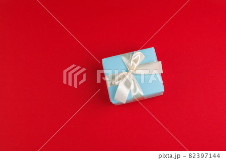 beautiful gift box wrapped in holiday paper with bow, top view beautiful gift box wrapped in holiday paper with bow, top view 82397144