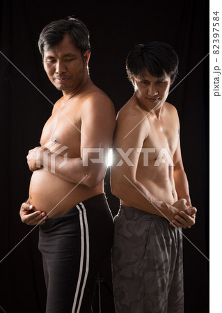 Two Asian sporty man in native shorts standing together comparing body muscle Two Asian sporty man in native shorts standing together comparing body muscle 82397584