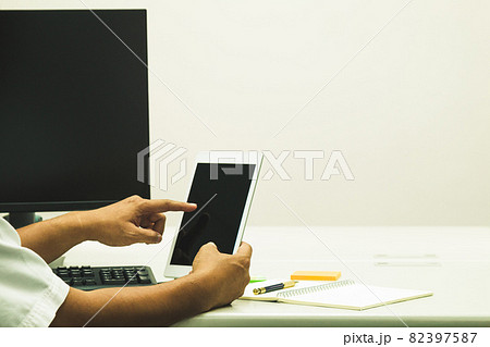 Asian Software engineer touch taplet to check information Asian Software engineer touch taplet to check information 82397587