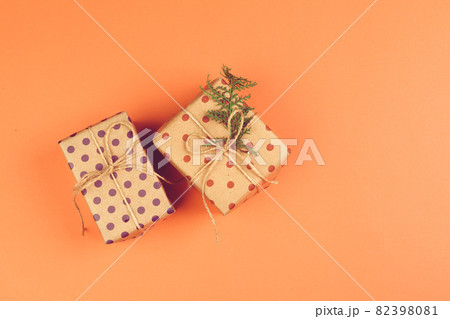 Present with a bow on orange background Present with a bow on orange background 82398081