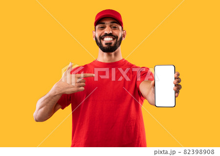 Arabic Delivery Guy Holding Smartphone With Blank Screen, Yellow Background 82398908