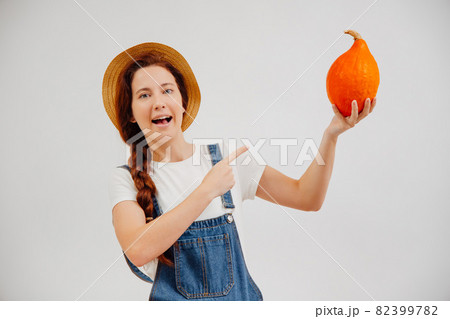 Female farmer calls for buying fresh organic vegetables pumpkin. Female farmer calls for buying fresh organic vegetables pumpkin. 82399782