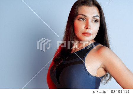 Healthy fit young woman in sportswear standing over a gray background 82401411
