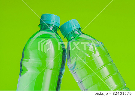 Clear and pure mineral water on a bright green background Clear and pure mineral water on a bright green background 82401579