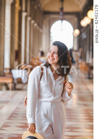 portrait of smiling woman in white clothes 82402179