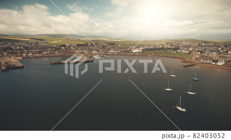 Yachts regatta race at sun ocean coast aerial. Modern buildings at traffic road. Campbeltown pier 82403052