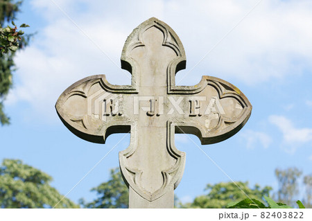 stone cross in front of a cloudy sky stone cross in front of a cloudy sky 82403822