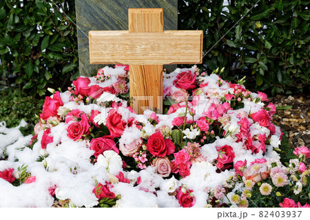 snow covered flower decoration from roses at a grave snow covered flower decoration from roses at a grave 82403937