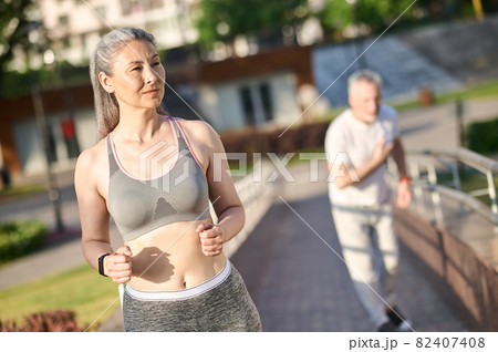 A mature couple having their morning jogging in the park 82407408