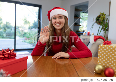 Happy caucasian woman wearing santa hat having video call at christmas time Happy caucasian woman wearing santa hat having video call at christmas time 82408170