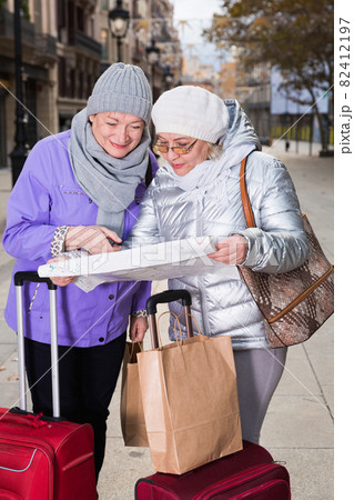 Senior females traveling with city map Senior females traveling with city map 82412197