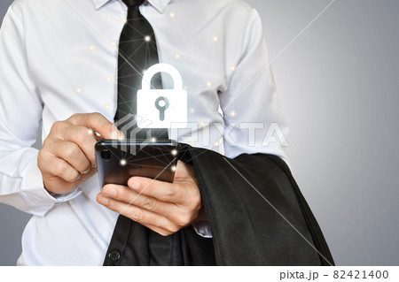 Businessman holding mobile phone with shield lock Businessman holding mobile phone with shield lock 82421400
