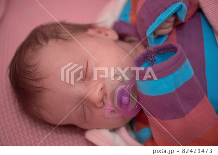 One month newborn baby sleeping in bed One month newborn baby sleeping in bed 82421473