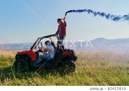 colorful torches while driving a off road buggy car 82422810