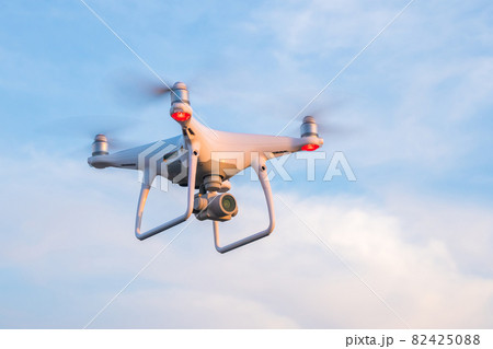 Flying drone with blue sky background Flying drone with blue sky background 82425088