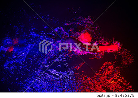 real triathlon athlete swimming in dark night 82425379