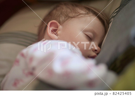 newborn baby sleeping at home in bed 82425405