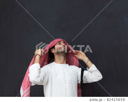 Portrait of young muslim man wearing traditional clothes Portrait of young muslim man wearing traditional clothes 82425659