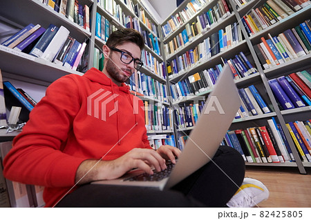 the students uses a notebook, laptop and a school library 82425805