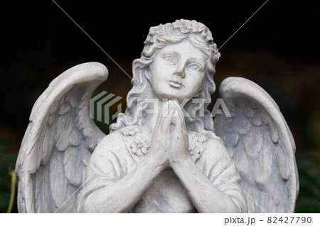 praying angel figure in a cemetery 82427790