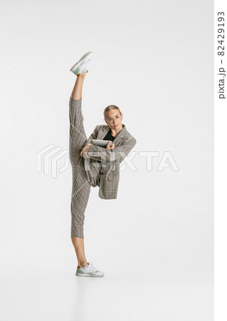 Full-length portrait of female employee in classical suit stretching isolated over white background Full-length portrait of female employee in classical suit stretching isolated over white background 82429193