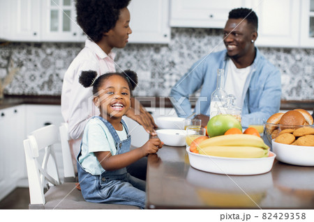 African family having breakfast together on bright kitchen 82429358